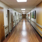 a hallway of patient rooms at South River Healthcare Center