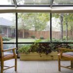 screened in sitting area overlooking a courtyard